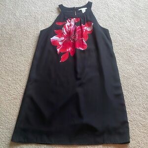 Black sheath dress with high neck.